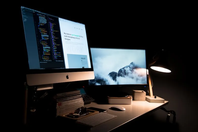 A developer comparing two approaches on a large monitor