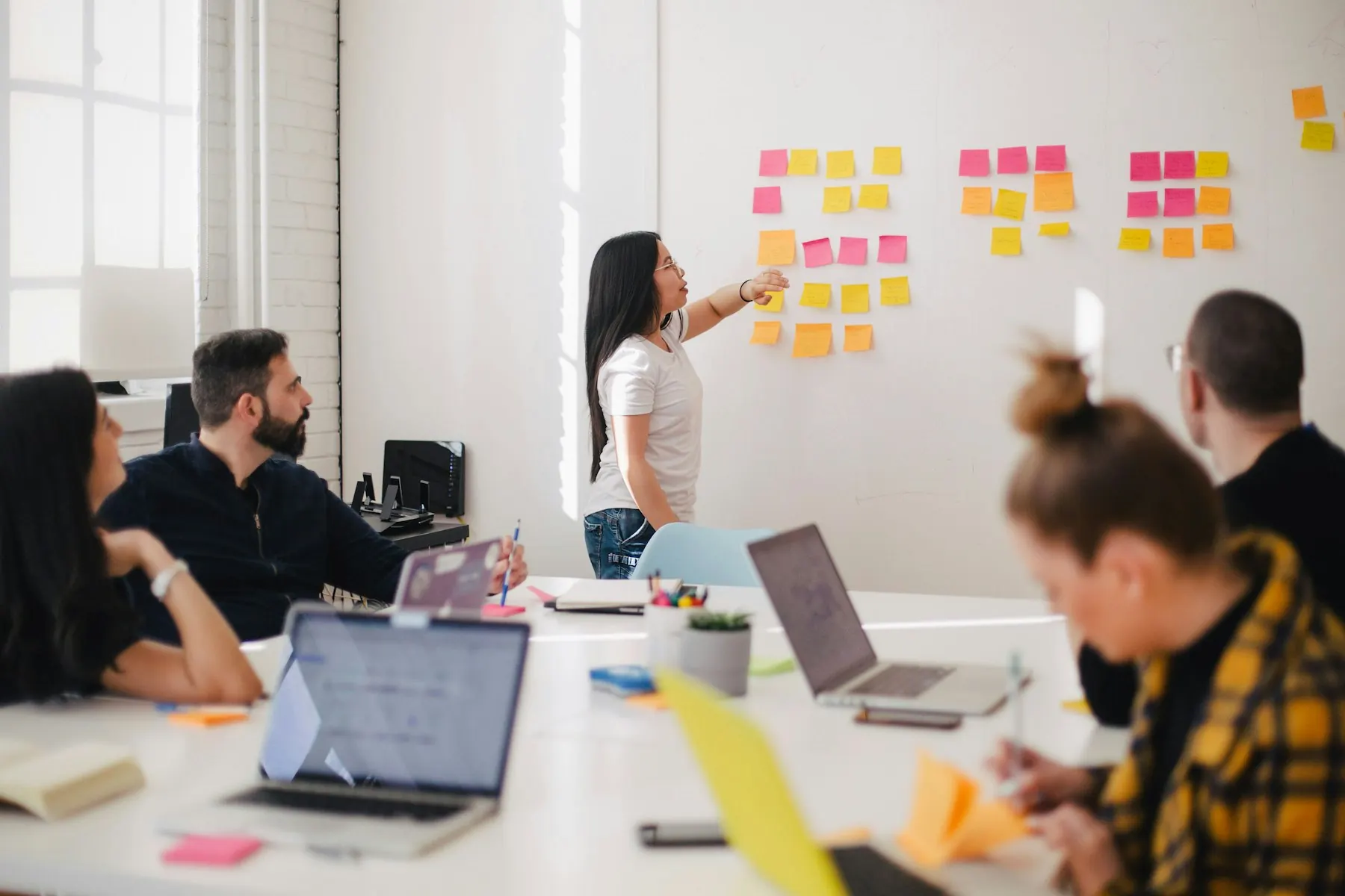 A small team talking around a table in a bright office